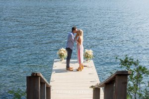 Newly engaged couple kiss on dock after their Donner Lake Proposal
