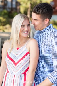 After their Donner Lake Proposal, newly engaged couple smiles and laughs together as they celebrate