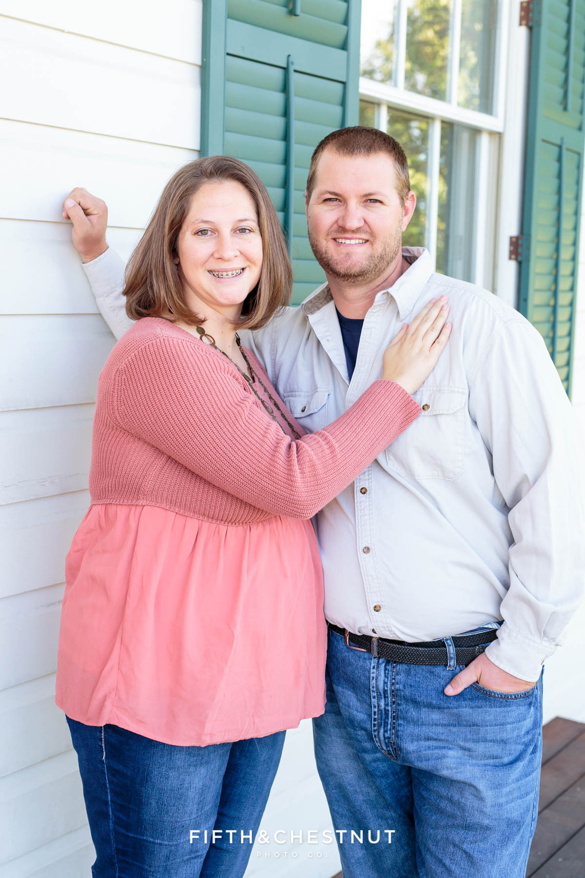 a couple stands on the patio of the old huffaker school for Bartley Ranch Portraits by Reno Family Photographer