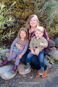 mom and two kids sit on rocks for Bartley Ranch Portraits by Reno Family Photographer