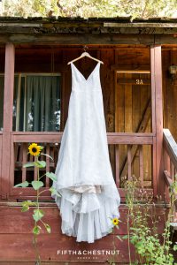 wedding dress hanging on cabin before a Greenhorn Creek Guest Ranch Wedding