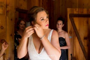 bride putting on her earrings for her Greenhorn Creek Guest Ranch Wedding