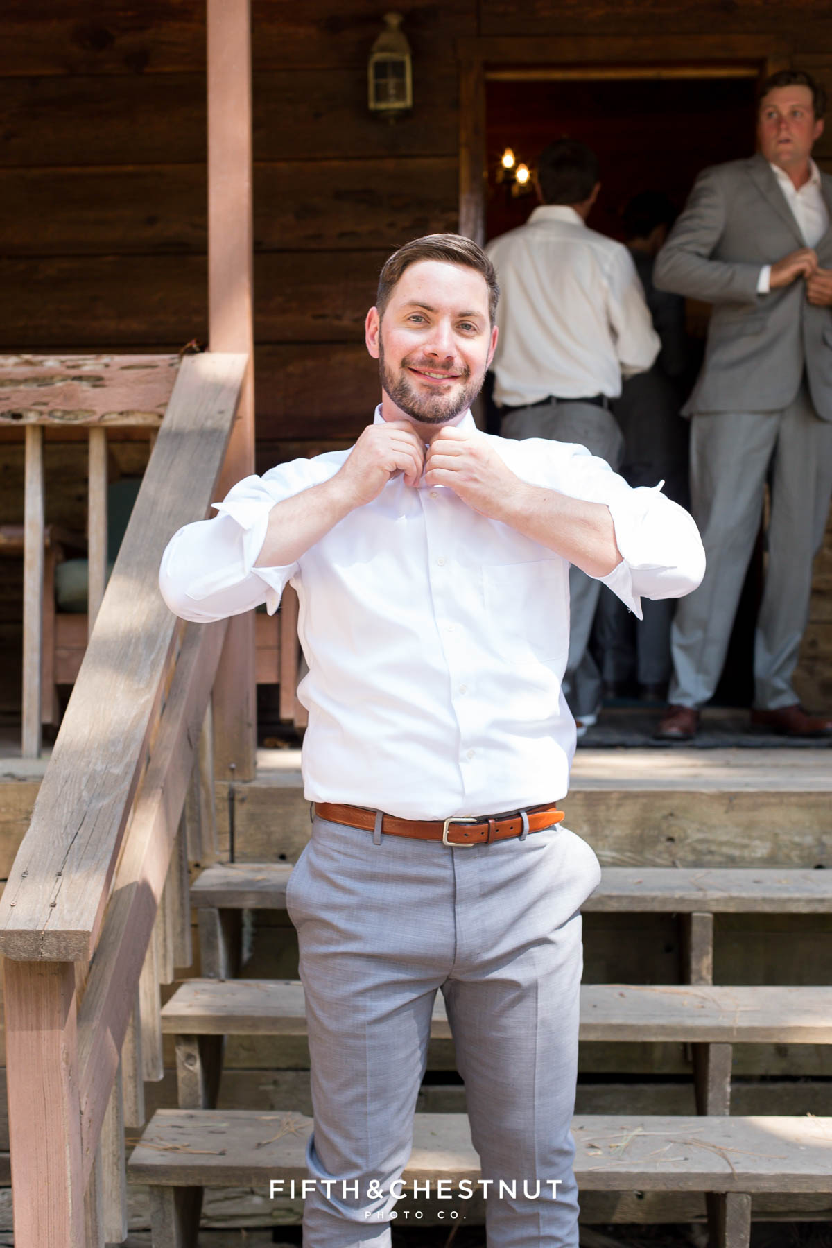 groom prepares for his Greenhorn Creek Guest Ranch Wedding in front of his cabin