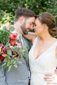 romantic bride and groom portrait with their heads together showing the bride's beautiful bouquet at their Greenhorn Creek Guest Ranch Wedding