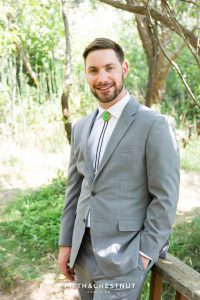 groom portrait under trees for his bright and summery wedding bouquet for a Greenhorn Creek Guest Ranch Wedding