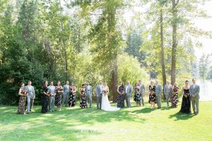 wedding party in gray suits and floral dresses for a bright and summery wedding bouquet for a Greenhorn Creek Guest Ranch Wedding