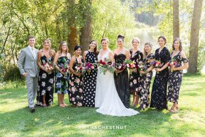 bride party wearing floral dresses for a wedding party in gray suits and floral dresses for a bright and summery wedding bouquet for a Greenhorn Creek Guest Ranch Wedding