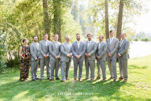 groomsmen in gray and a groomswoman in floral dress for a wedding party in gray suits and floral dresses for a bright and summery wedding bouquet for a Greenhorn Creek Guest Ranch Wedding