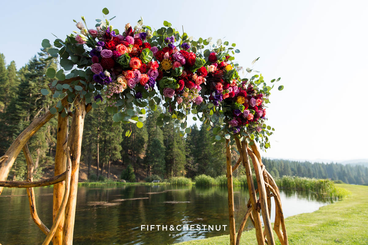 wedding arch details with bright summer flowers