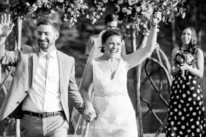 bride and groom walk back down the aisle as husband and wife
