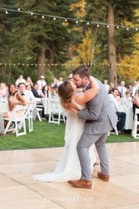 groom lowers bride on the dance floor for a kiss before their first song is over as hubsband and wife