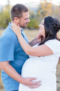 Husband caresses his pregnant wife's cheek for fall maternity portraits by Reno Maternity Photographer