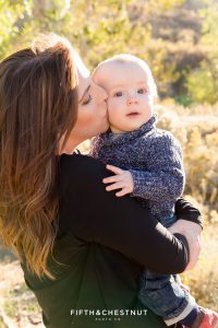 Mother kisses her baby's cheek for Mayberry Park Portraits in the fall