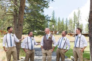 Groom laughs with his groomsmen before a PJ's at Gray's Crossing wedding in the forest