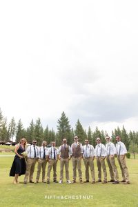 Wedding party stands in field with their sunglasses on before a gay wedding at PJ's at Gray's Crossing by Truckee Wedding Photographer
