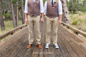 Portrait of grooms' shoes at they stand together on wooden bridge for their same-sex wedding in Truckee