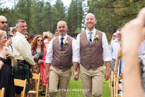 Grooms smile as they head down the aisle hand-in-hand for their PJ's at Gray's Crossing wedding
