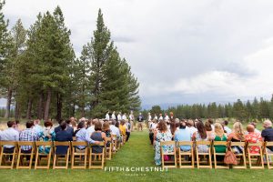 Wedding ceremony takes place under moody and cloudy skies in Truckee for a PJ's at Gray's Crossing wedding