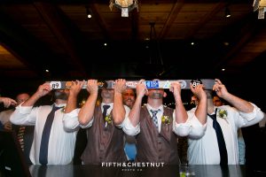 grooms and groomsmen do shots from a shotski during a Truckee Wedding at PJ’s at Gray’s Crossing