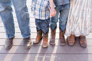 A closeup of a family wearing boots for their rustic Tahoe Maternity Portraits