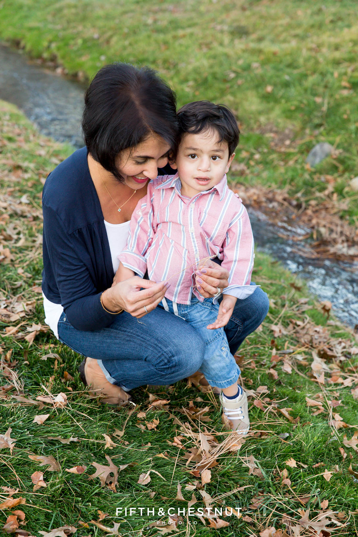 a mother and her youngest son play by a creek for their Caughlin Ranch Family Portraits
