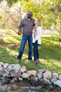 couple laughs with each other for their fall family portraits at Caughlin Ranch