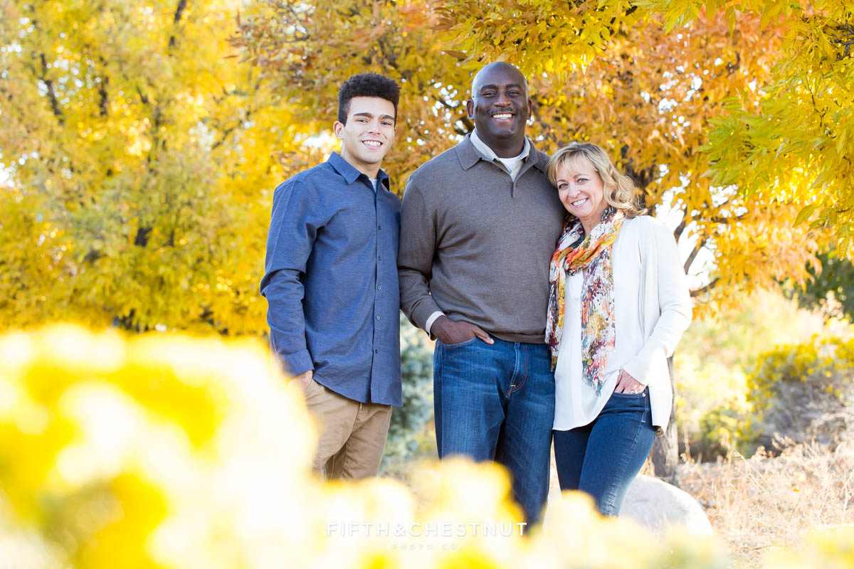 Family of three surrounded by fall foliage for Reno fall family portraits