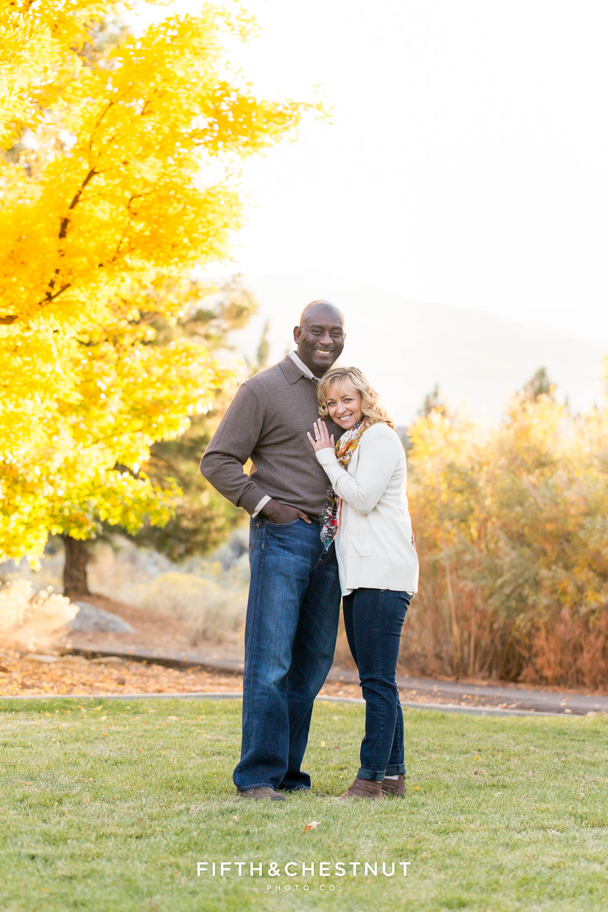 couple snuggles during Reno fall family portraits