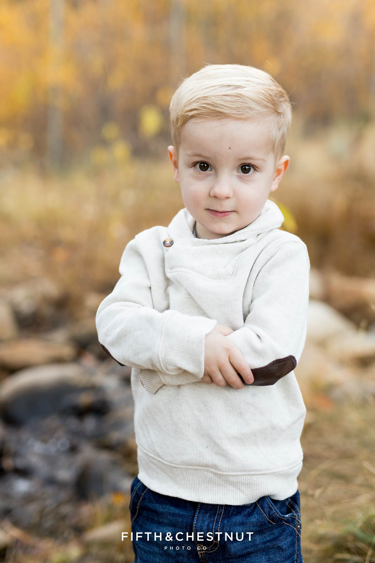 toddler with serious expression poses for his Fall Galena Creek Portraits