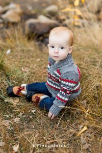 A baby sits in grass for his Fall Galena Creek Portraits