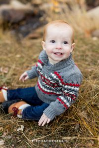 baby smiles and looks up for his Fall Galena Creek Portraits