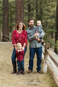 Sweet family of four poses for reno family photos at galena creek park wearing red and gray