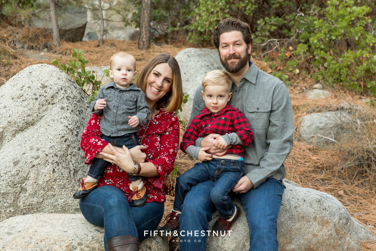 Family of four wearing gray and red at the galena creek fish hatchery for family portraits by Reno family photographer
