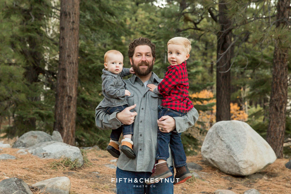 Portrait of father and sons with pine trees in the background