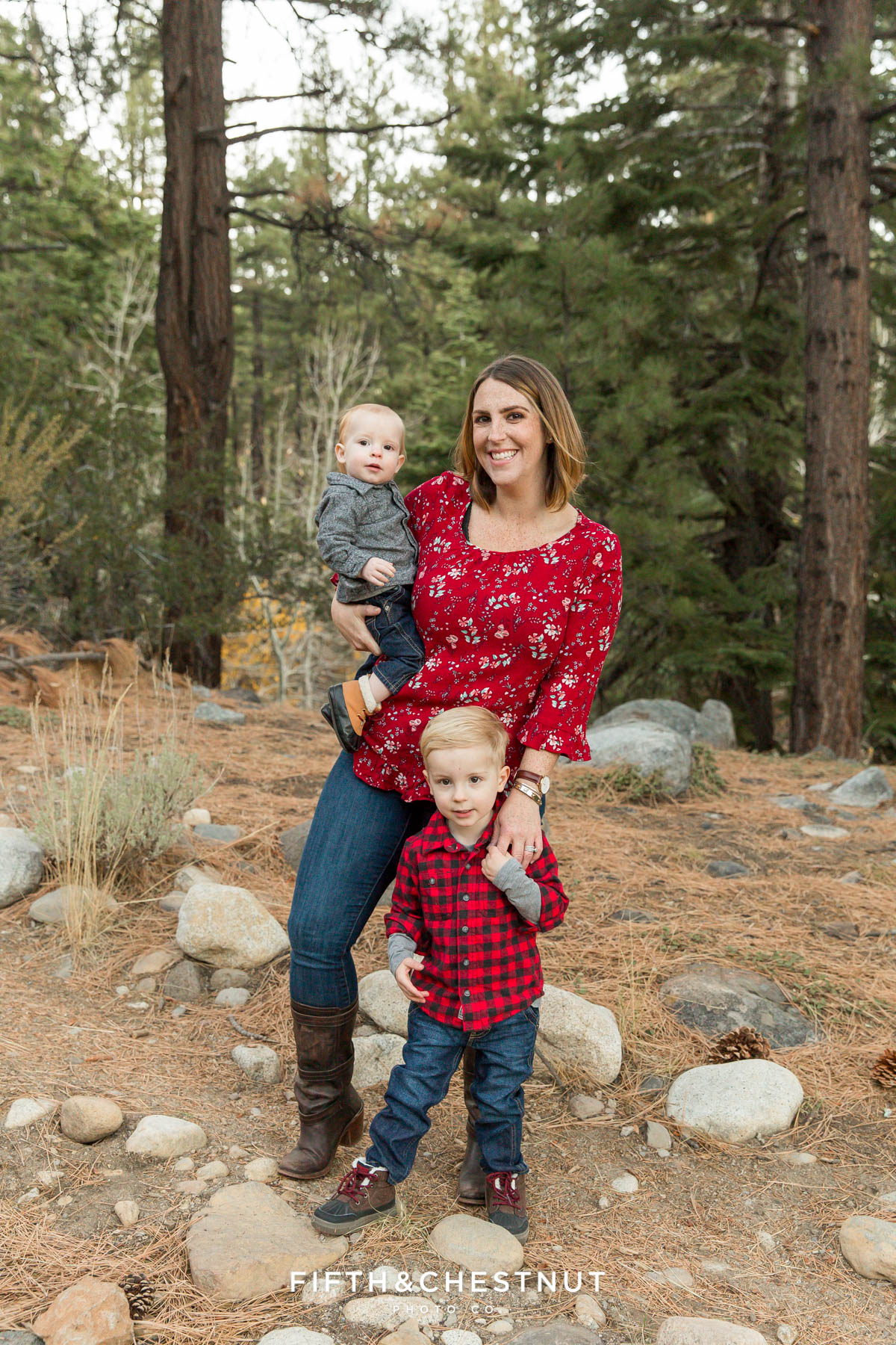 portrait of mother and sons with pine trees and rocks in the background