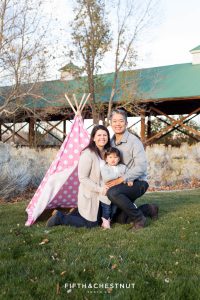 Family of three in front of a pink polka dotted teepee for their Adorable Reno Family Portraits at Bartley Ranch