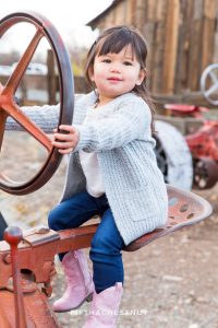 Toddler driving tractor at Bartley Ranch for Adorable Reno Family Portraits by Reno Family Photographer