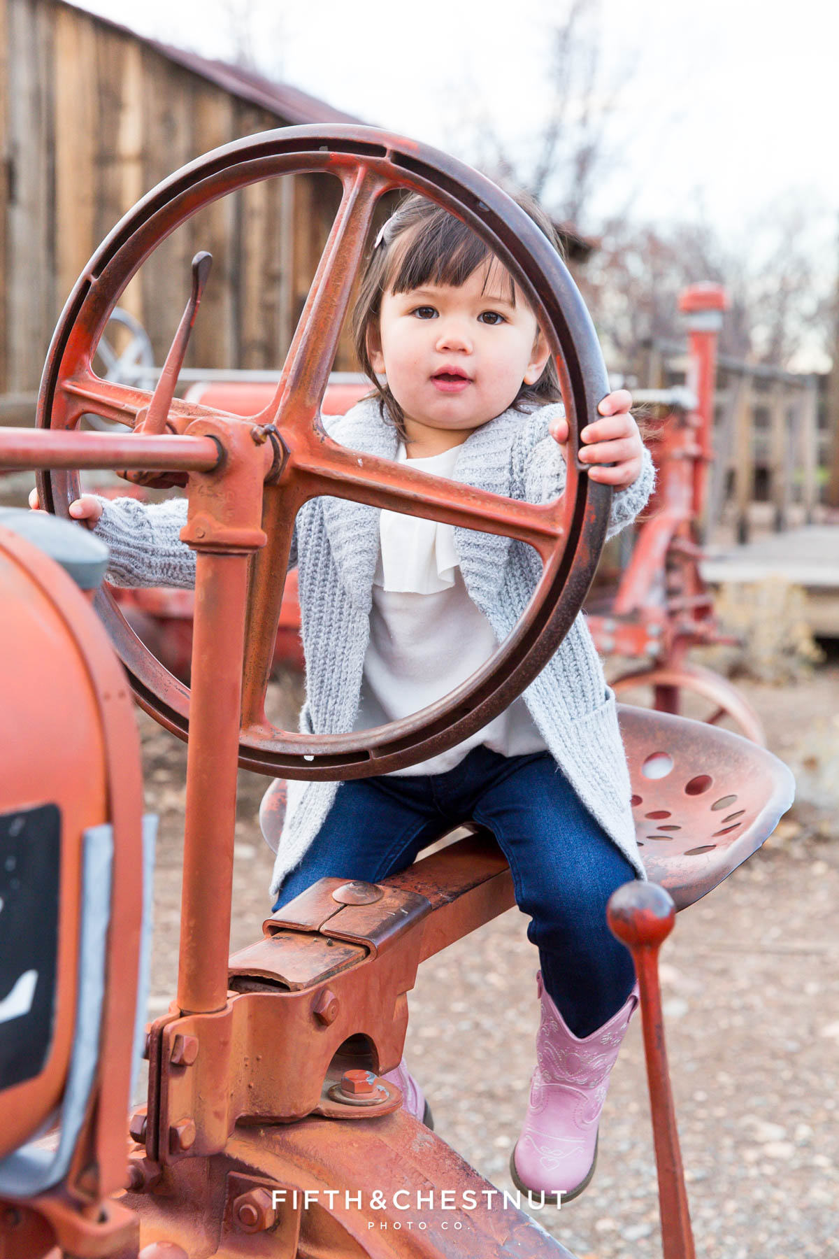 Toddler driving tractor at Bartley Ranch for Adorable Reno Family Portraits by Reno Family Photographer