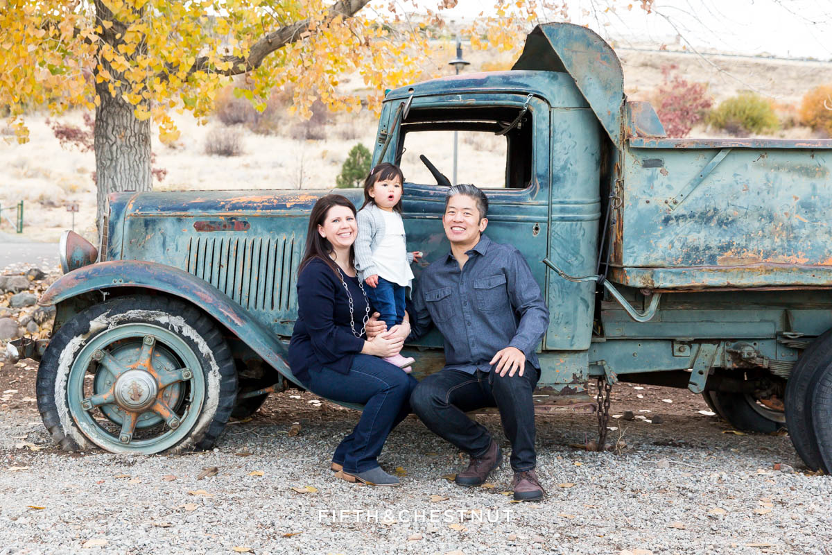 Family sitting on old blue truck at Bartley Ranch for their Adorable Reno Family Portraits by Reno Family Photographer