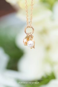 gold and pearl bracelet hanging from a flower for a zephyr cove wedding