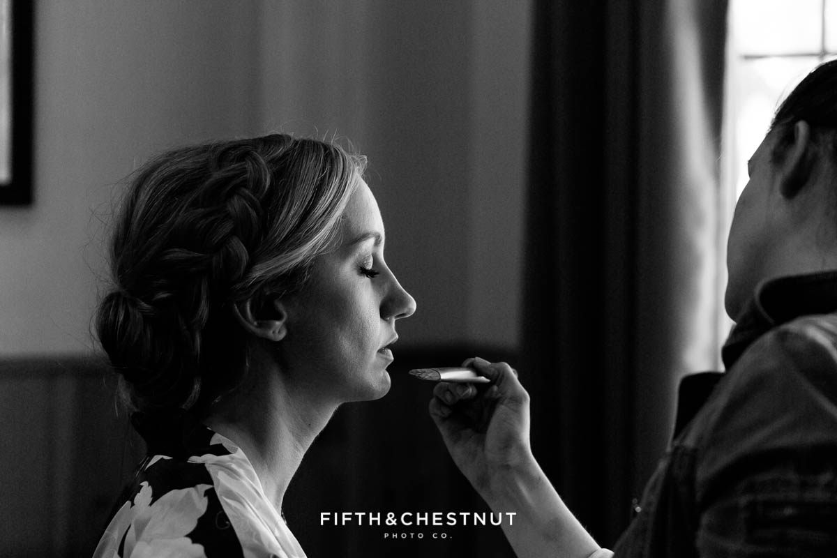 Greco Rose Beauty applying makeup to a zephyr cove bride