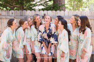 bride and bridesmaids in custom floral satin robes before getting dressed for a zephyr cove wedding by lake tahoe wedding photographer