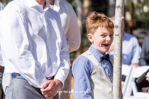 ring bearer spots the camera at a wedding ceremony in lake tahoe