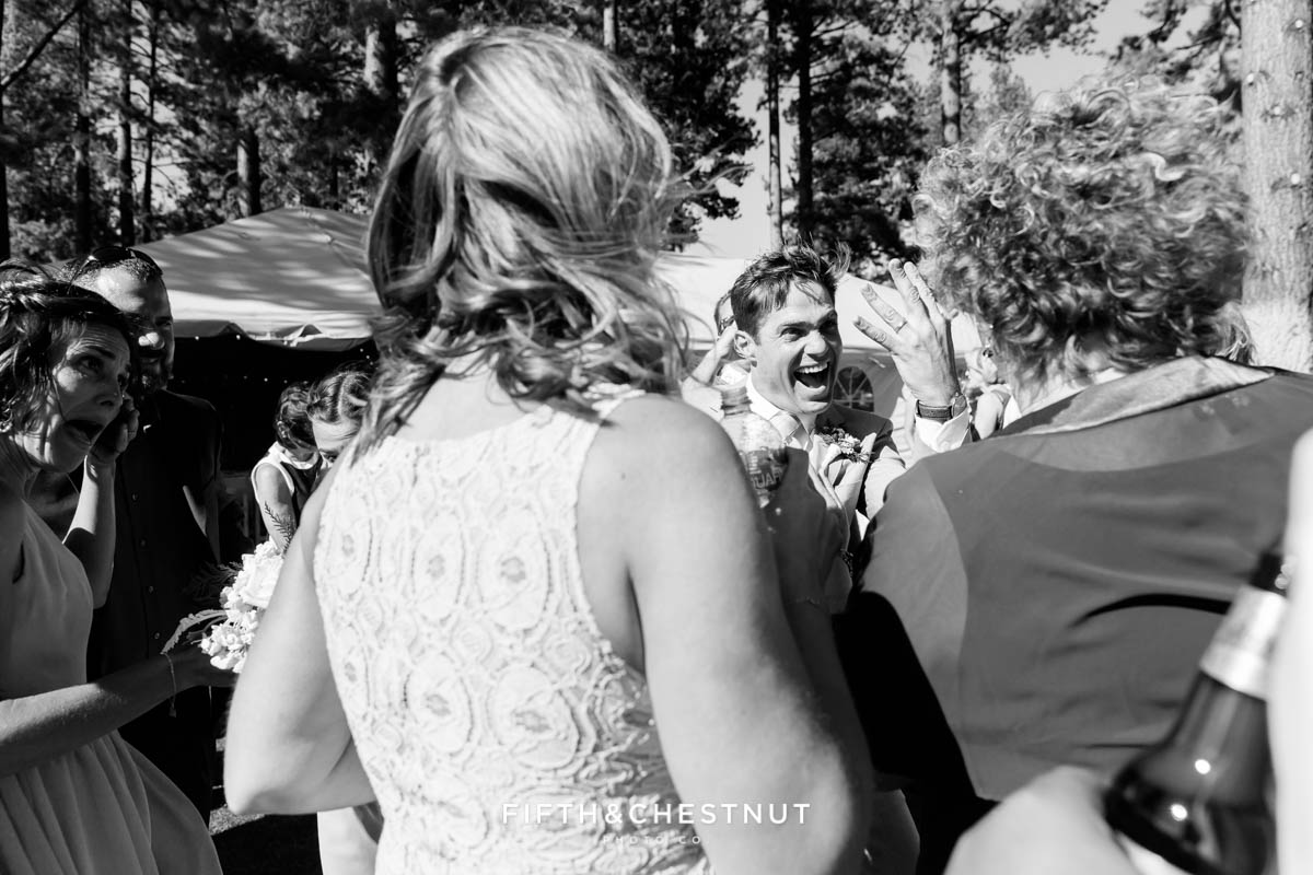 groom shows off his ring to guests at a lake tahoe wedding