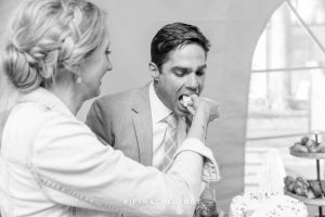 groom eats cake at his lake tahoe wedding