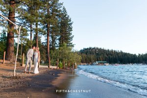 bride and groom kiss on the beach at their lake tahoe wedding