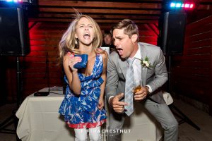 groom and guest lip sync to whitney houston's "I wanna dance with somebody" at a tahoe wedding