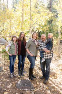 Family stands in front of aspen trees together for Galena Creek Reno fall portraits