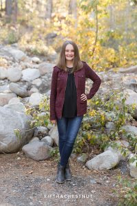 teenage girl in burgundy jacket poses for Galena Creek Reno fall portraits by Reno Family Photographer
