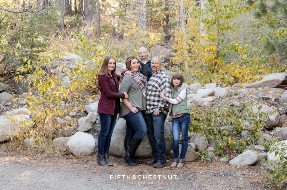 a family snuggles close together for Galena Creek Reno fall portraits by Reno Family Photographer